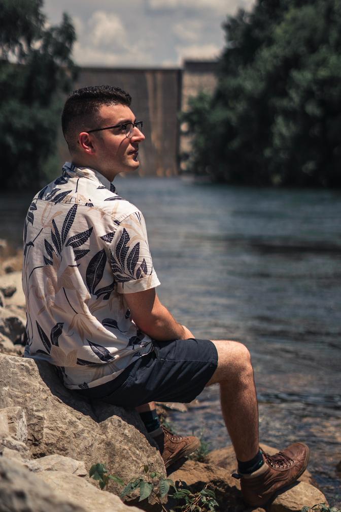 Me sitting on a rock near a river